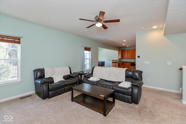 living room featuring ceiling fan and light carpet