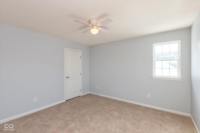 empty room featuring light carpet and ceiling fan