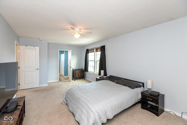 carpeted bedroom featuring a textured ceiling and ceiling fan