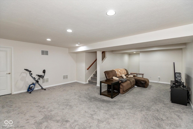 interior space with a textured ceiling and carpet flooring