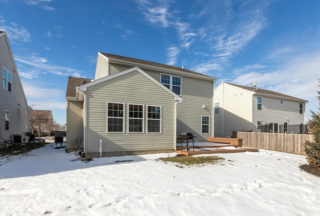 snow covered rear of property with central air condition unit