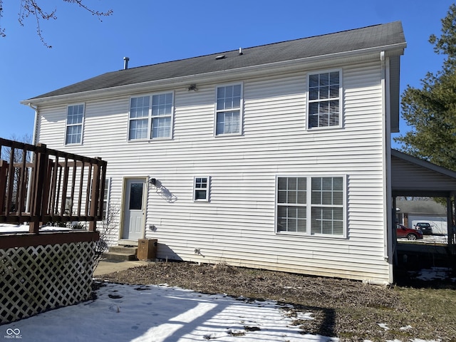 back of property featuring a wooden deck and a patio