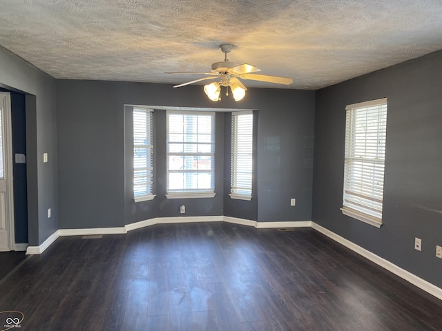 unfurnished room featuring a textured ceiling, ceiling fan, and dark hardwood / wood-style floors