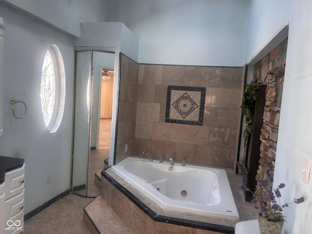 208 Winding Dr, Alexandria, IN 46001 - bathroom with tiled bath and tile patterned flooring