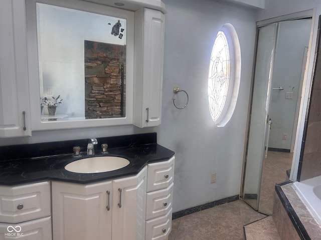 208 Winding Dr, Alexandria, IN 46001 - bathroom featuring a relaxing tiled tub and vanity