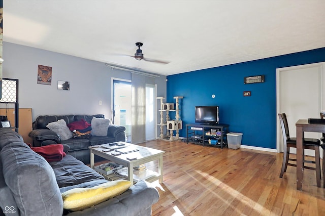 living room with ceiling fan and light wood-type flooring