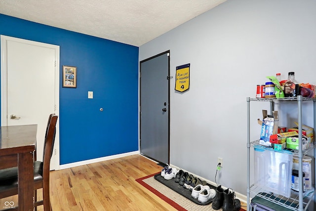 interior space featuring hardwood / wood-style floors and a textured ceiling