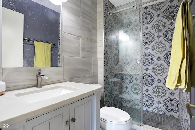 bathroom featuring vanity, tile walls, an enclosed shower, and toilet