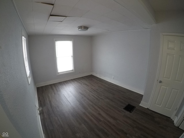 spare room with dark hardwood / wood-style floors