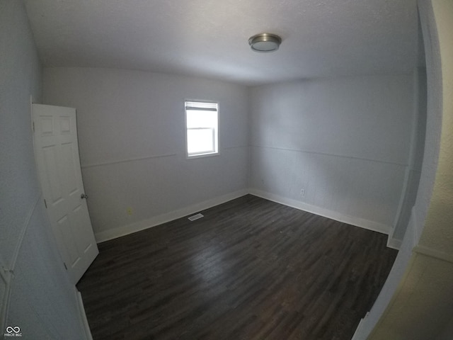 empty room with dark hardwood / wood-style floors