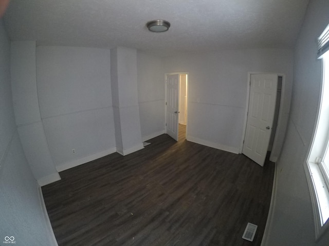 spare room with dark hardwood / wood-style flooring