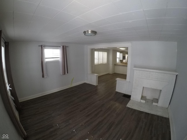 unfurnished living room featuring dark hardwood / wood-style floors and a fireplace