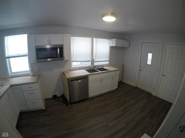 kitchen featuring sink, dark hardwood / wood-style flooring, white cabinetry, and appliances with stainless steel finishes