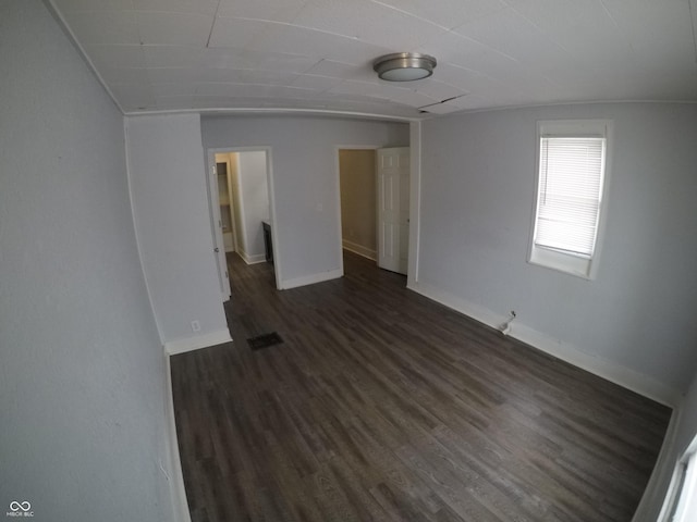 empty room with dark hardwood / wood-style floors