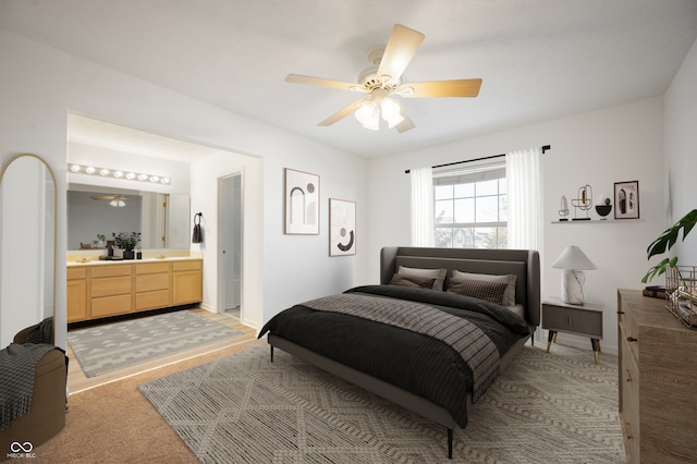 bedroom with ceiling fan, connected bathroom, and light colored carpet