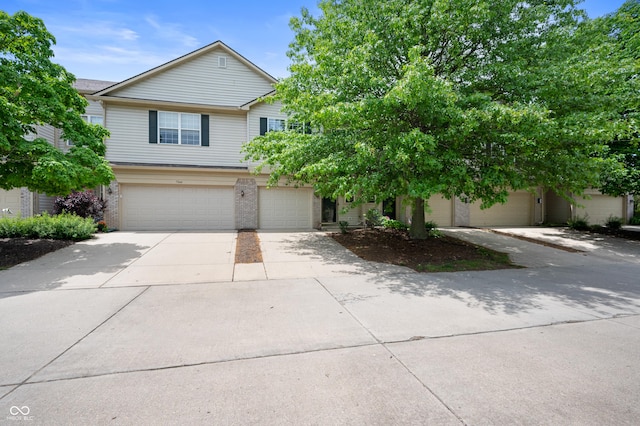 7042 Tyler Ln, Indianapolis, IN 46217 - view of front of property with an attached garage, concrete driveway, and brick siding