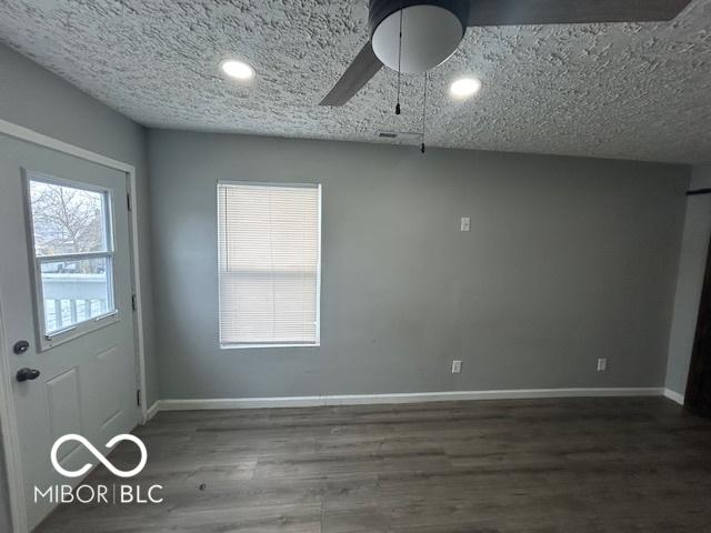 interior space featuring dark wood-type flooring and ceiling fan