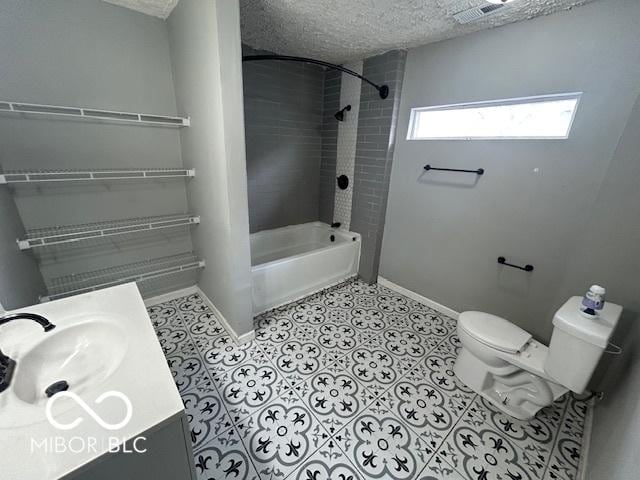 full bathroom with tiled shower / bath combo, vanity, a textured ceiling, and toilet