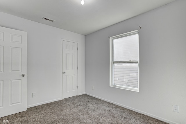 carpeted spare room with plenty of natural light