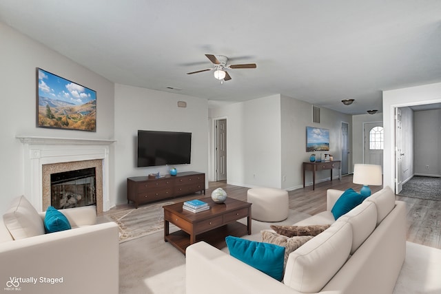 living room with ceiling fan and light hardwood / wood-style flooring