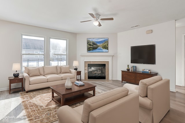 living room with ceiling fan and light hardwood / wood-style flooring