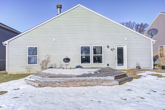 snow covered property featuring a wooden deck