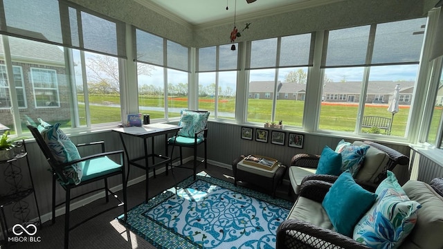 sunroom featuring ceiling fan