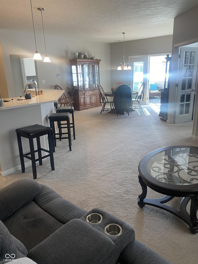 carpeted living room featuring a textured ceiling