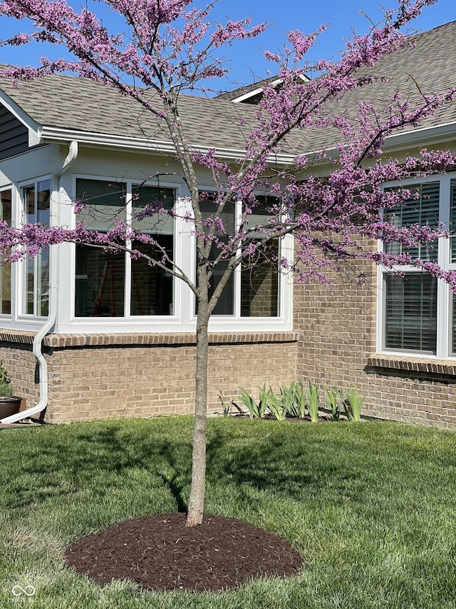 view of side of home featuring a yard