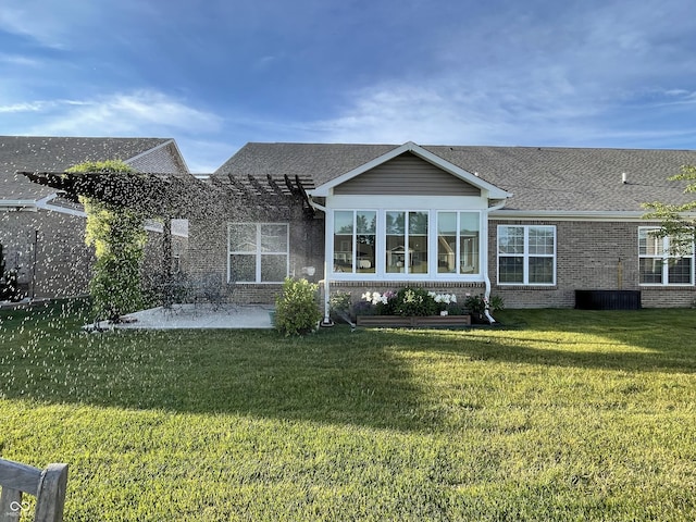 rear view of property with a yard and a patio area