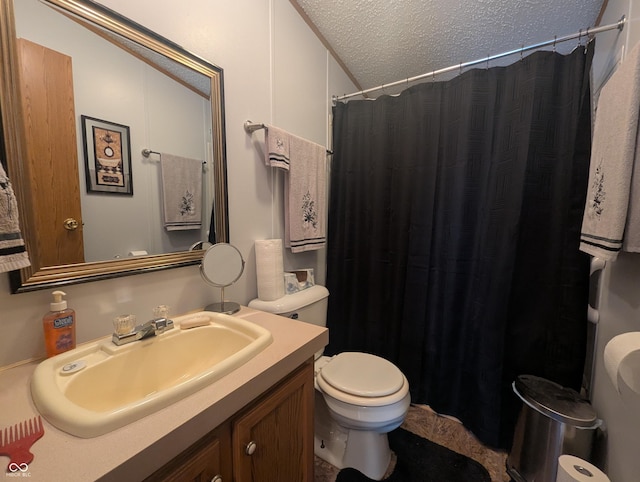 bathroom with a shower with curtain, vanity, a textured ceiling, and toilet