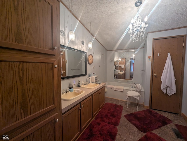 bathroom featuring vanity, a notable chandelier, a textured ceiling, vaulted ceiling, and a tub