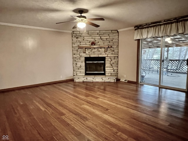 unfurnished living room with crown molding, baseboards, ceiling fan, a fireplace, and wood finished floors