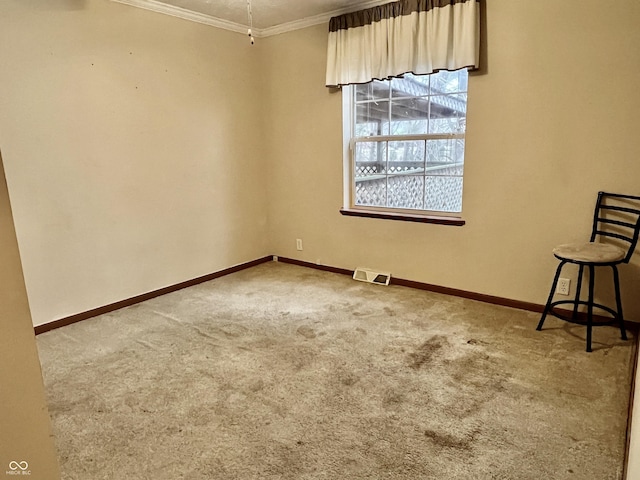 carpeted empty room featuring ornamental molding