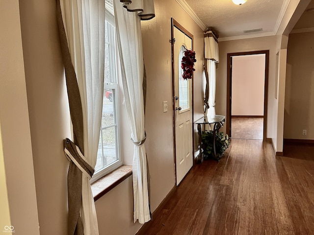 corridor featuring ornamental molding, dark hardwood / wood-style floors, and a textured ceiling