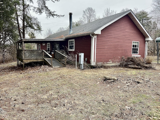 back of property featuring a wooden deck