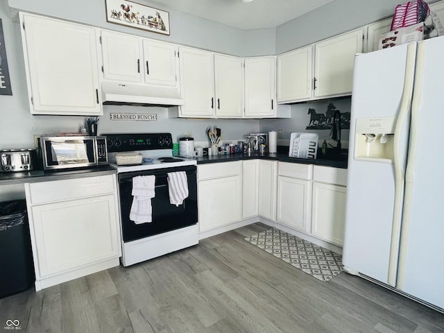 kitchen with light hardwood / wood-style flooring, white fridge with ice dispenser, electric range oven, and white cabinetry