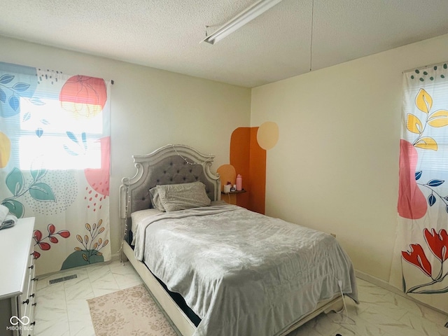 bedroom featuring a textured ceiling