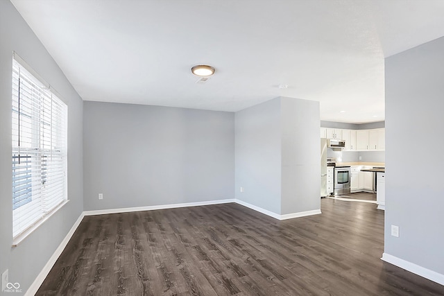 unfurnished room featuring dark hardwood / wood-style flooring