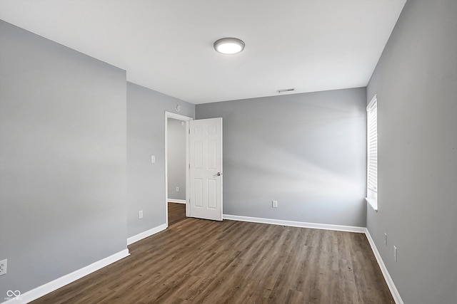 unfurnished room featuring dark hardwood / wood-style flooring