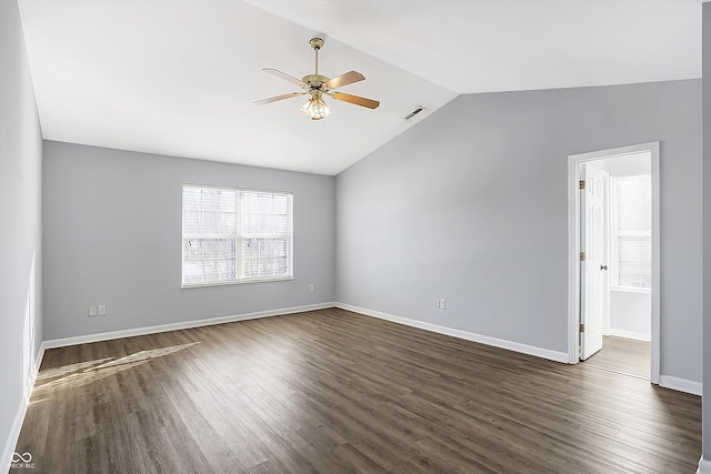 empty room featuring ceiling fan, dark hardwood / wood-style flooring, and vaulted ceiling