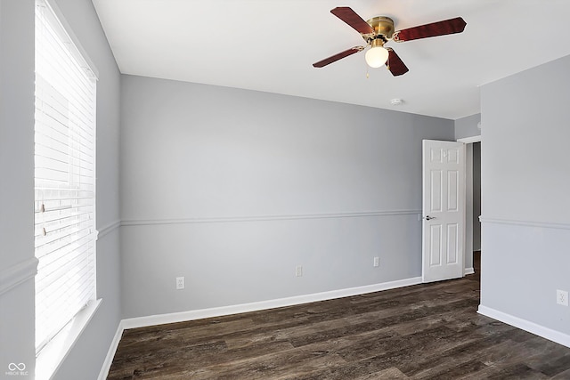 unfurnished room with ceiling fan and dark hardwood / wood-style flooring