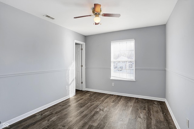 unfurnished room with ceiling fan and dark hardwood / wood-style flooring