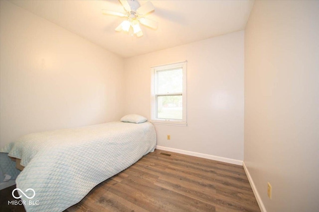 bedroom with ceiling fan and dark wood-type flooring