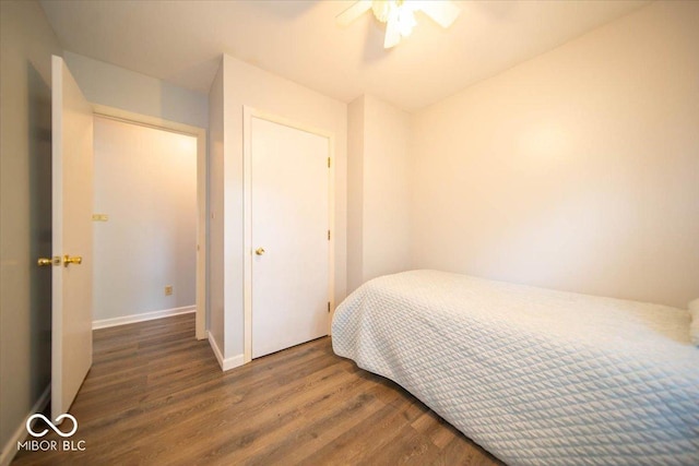 bedroom featuring ceiling fan, a closet, and dark hardwood / wood-style flooring