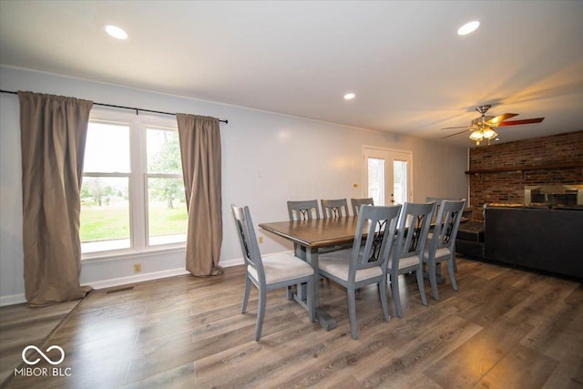 dining space featuring dark wood-type flooring, french doors, and ceiling fan