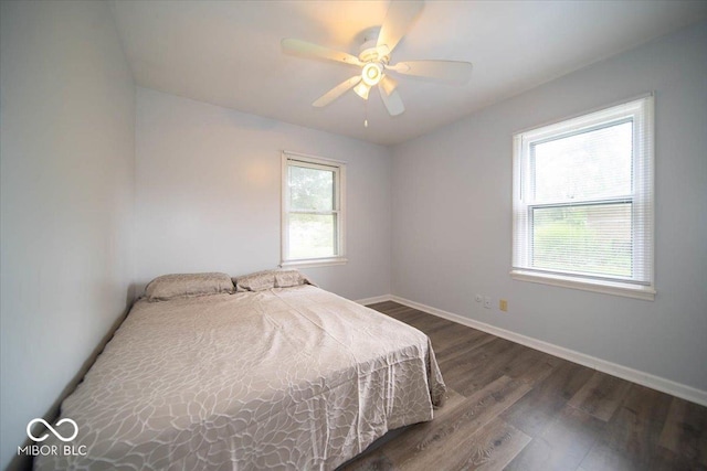 bedroom with ceiling fan and dark hardwood / wood-style flooring