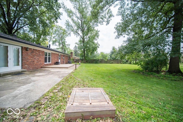 view of yard featuring french doors and a patio area