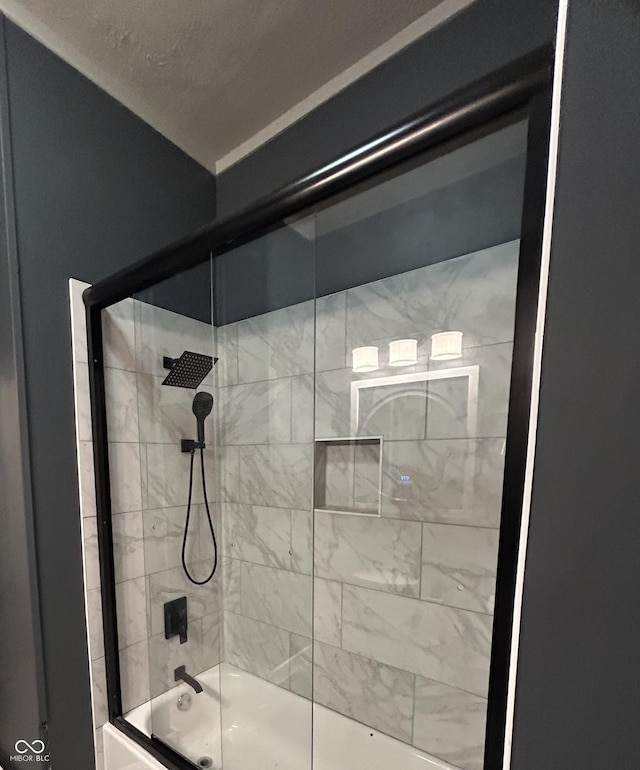 bathroom with shower / bath combination with glass door