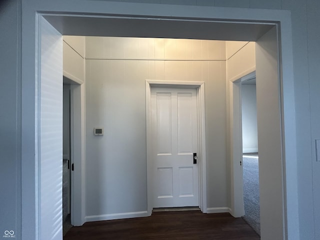 corridor featuring dark wood-type flooring